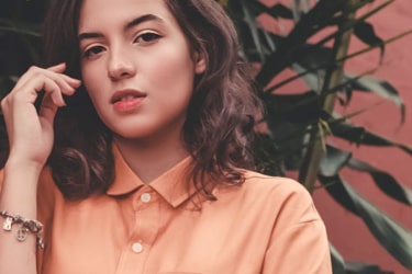 Photo of beautiful woman with brown hair and orange shirt