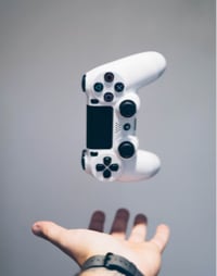 A gamepad over a person's hand, as if floating