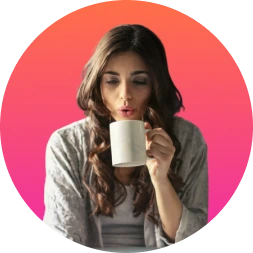 A beautiful woman drinking some coffee and watching courses on computer